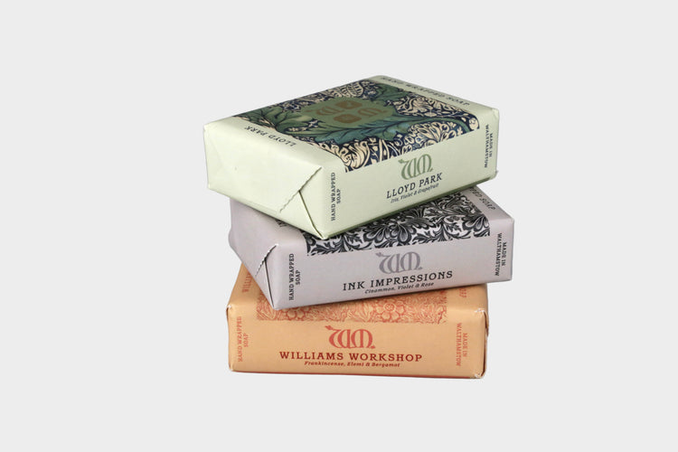 Stack of Williams Workshop product boxes on a gray background