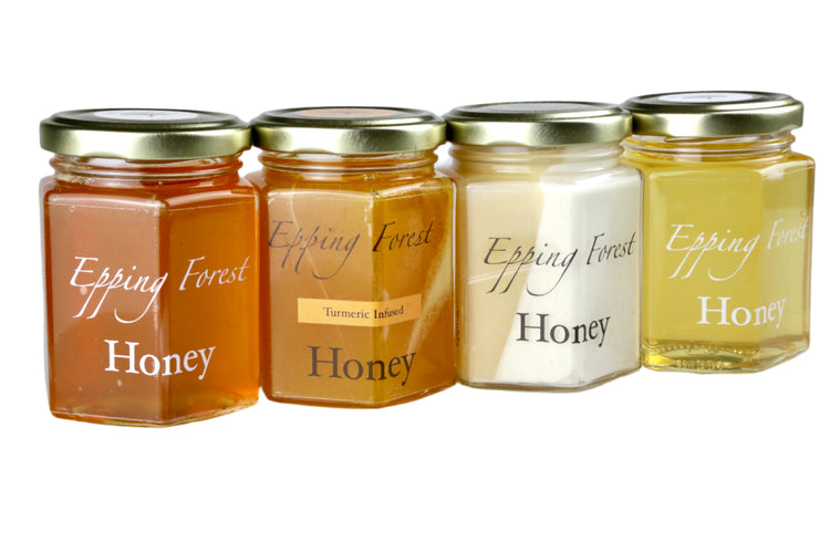 Four jars of Epping Forest Honey on a white background