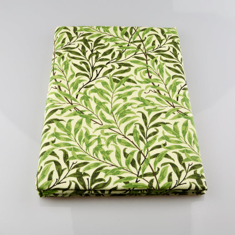 Folded fabric with green leaf pattern on a gray background