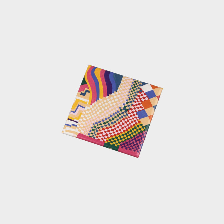 Colorful patterned fabric square on a gray background