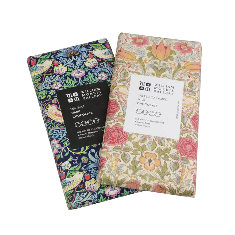 Two William Morris Gallery chocolate bars with floral packaging on a gray background
