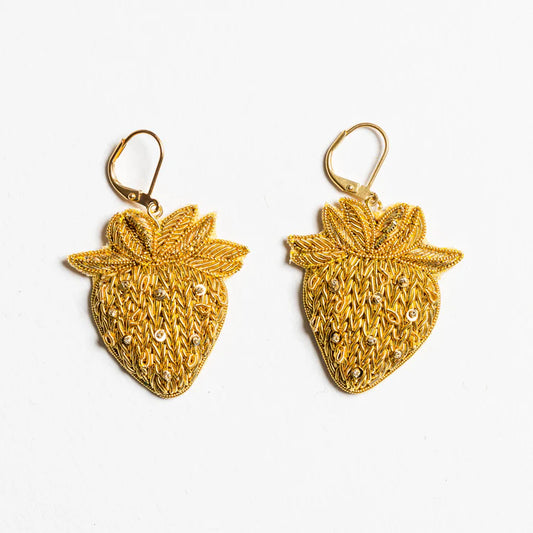 Gold strawberry-shaped earrings on a white background