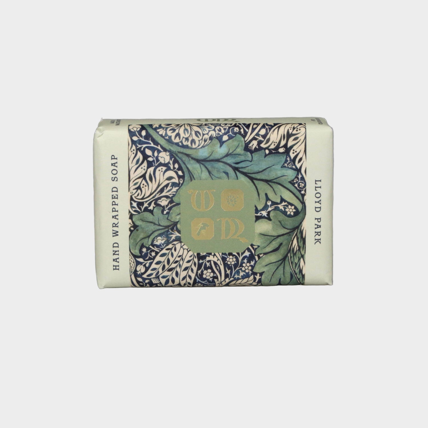 Hand-wrapped soap bar with decorative packaging on a gray background