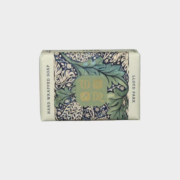Hand-wrapped soap bar with decorative packaging on a gray background