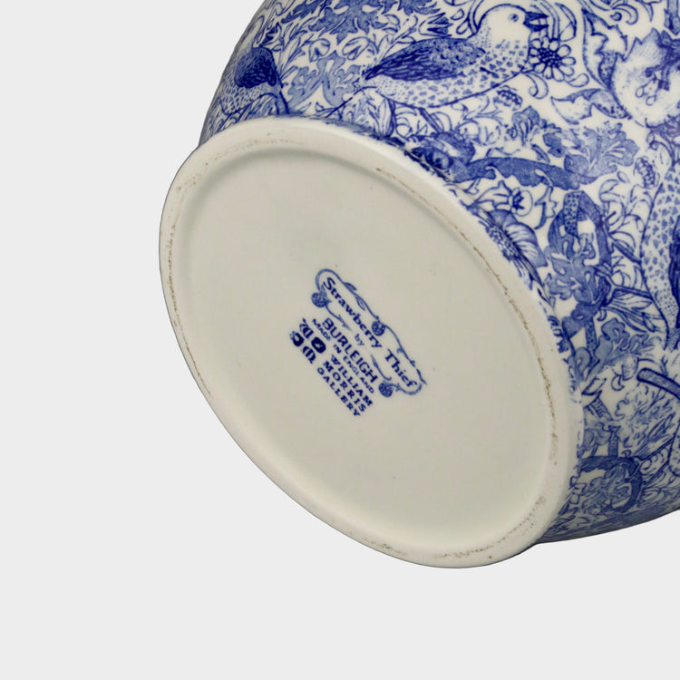 Blue and white patterned vase with a visible brand logo on a gray background