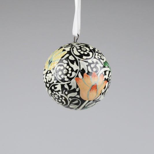 Decorative ball ornament with floral design on a gray background