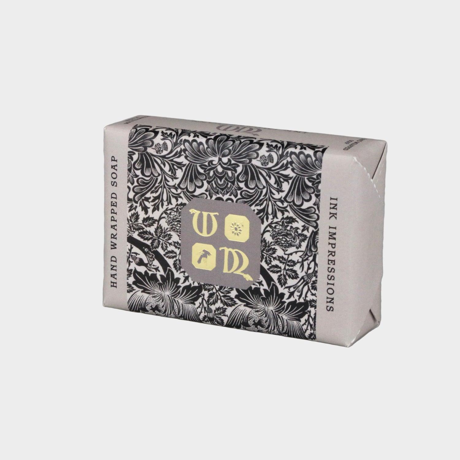 Hand-wrapped soap with decorative packaging on a gray background