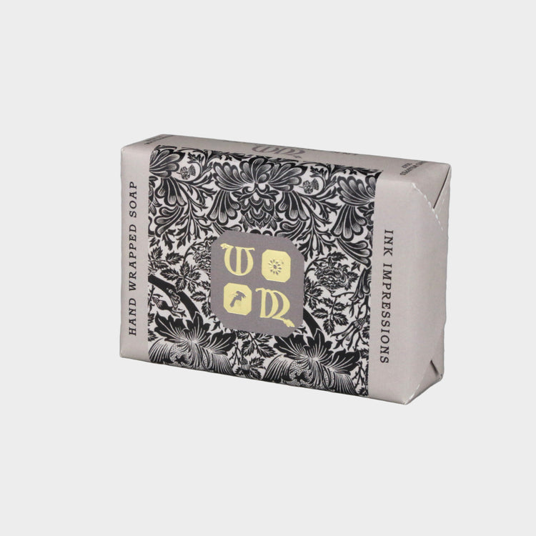 Hand-wrapped soap with decorative packaging on a gray background