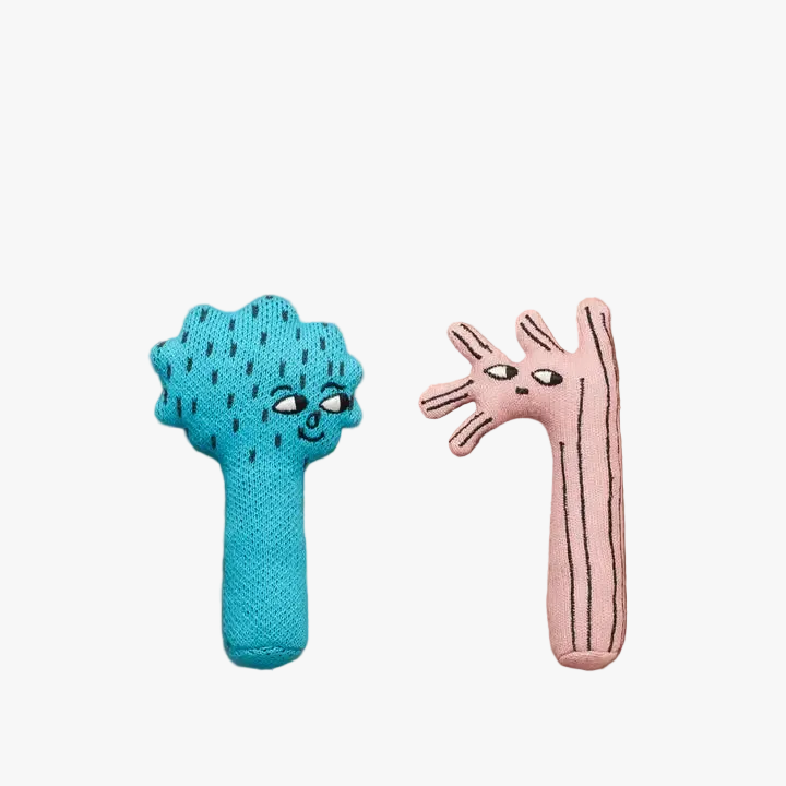Two knitted toys, one blue and one pink, on a brown background