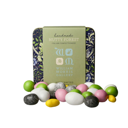 Decorative tin with 'Nutty Forest' branding surrounded by colorful candies on a gray background