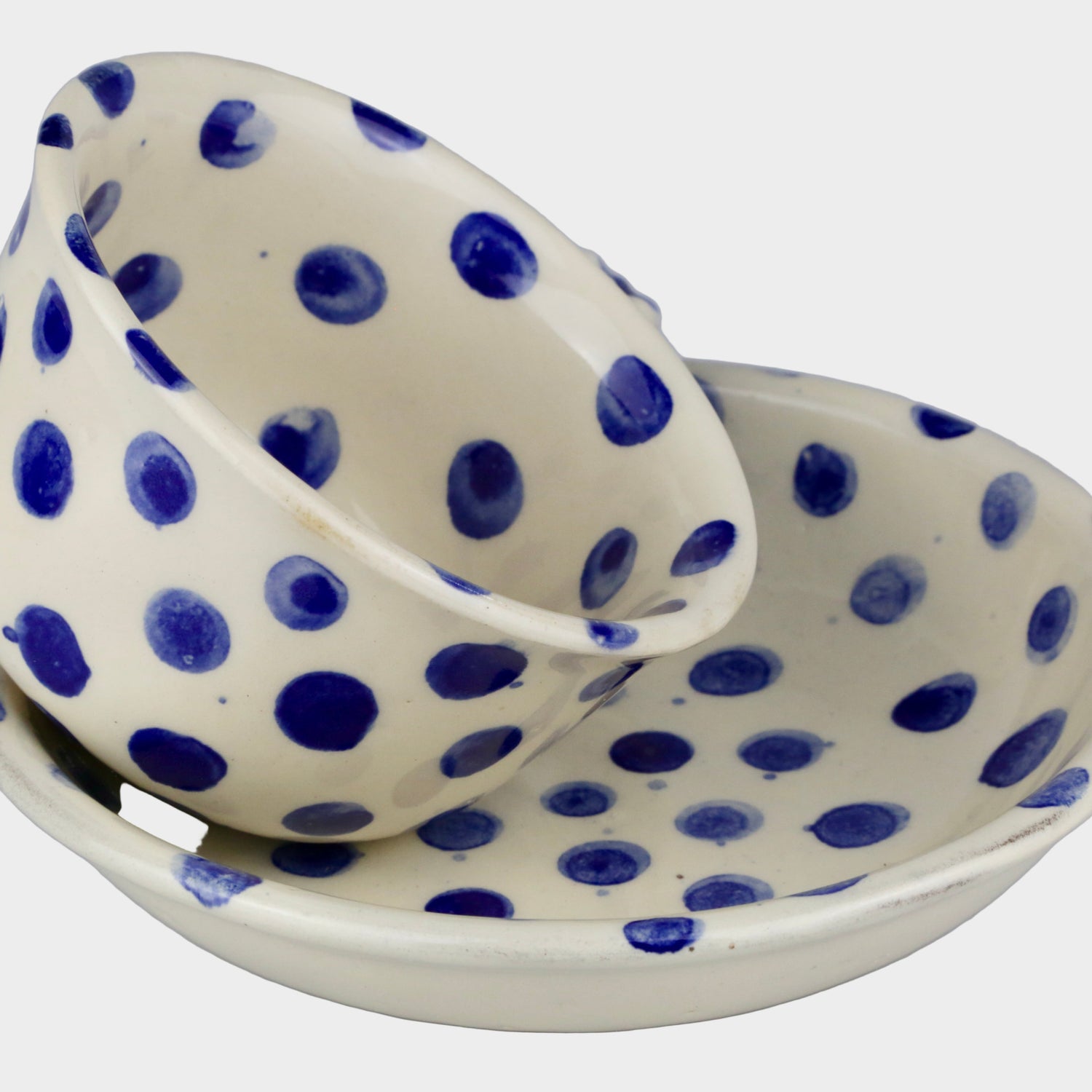 Ceramic dish with blue polka dots on a gray background