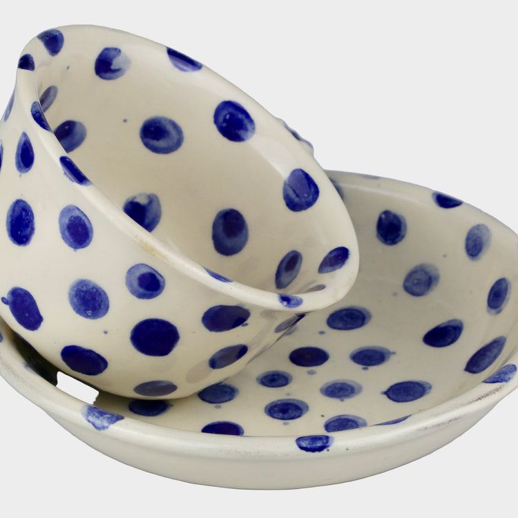 Ceramic dish with blue polka dots on a gray background