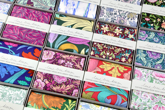 Collection of colorful fabric swatches with brand name on a white background