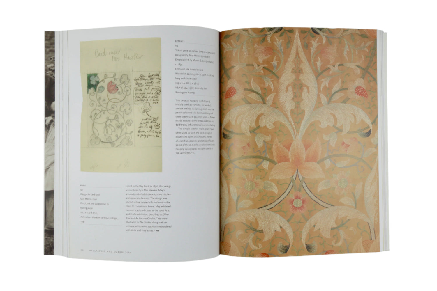 Open book displaying decorative text and pattern on a gray background