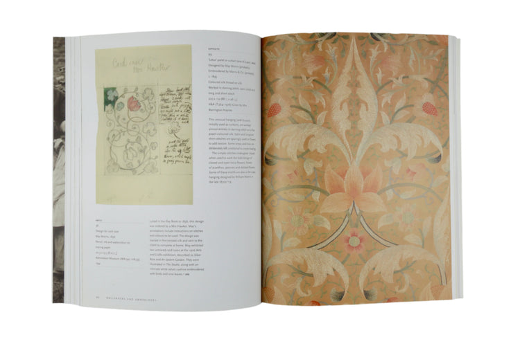 Open book displaying decorative text and pattern on a gray background