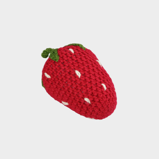 Crocheted strawberry toy on a light gray background
