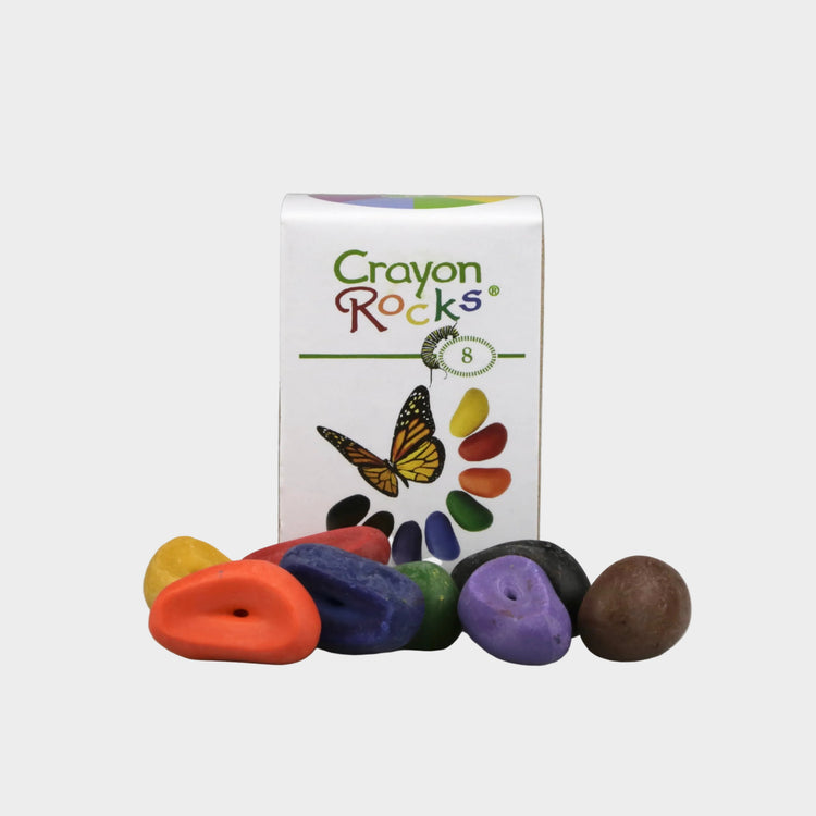Crayon Rocks packaging with colorful rocks on a gray background