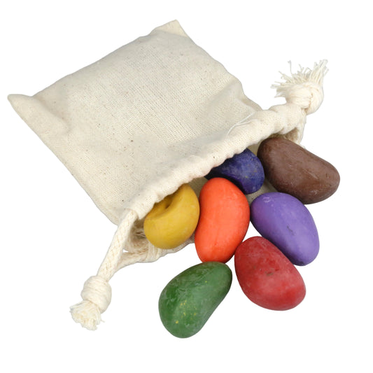 Colorful stones in a drawstring bag on a gray background