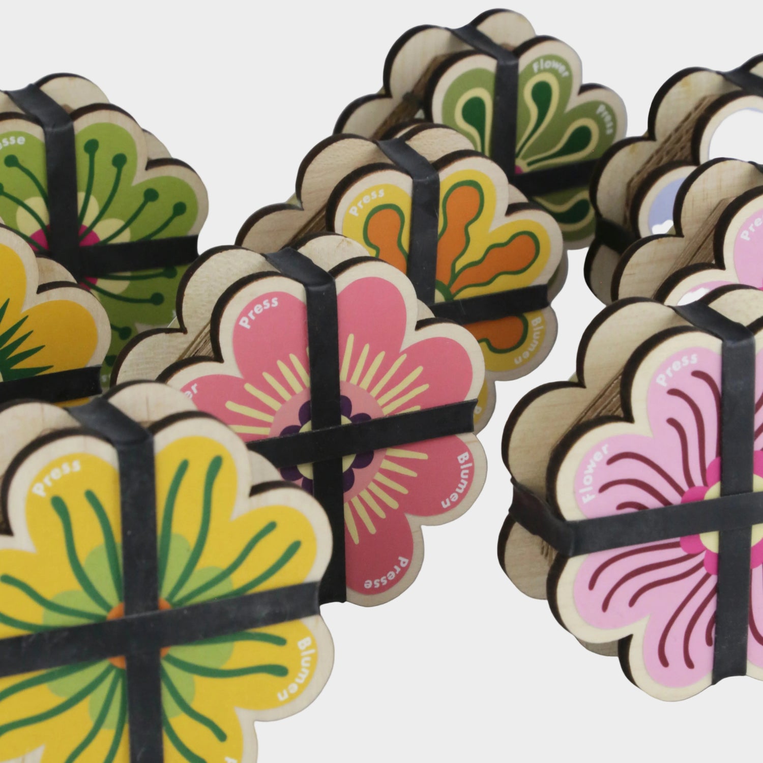 Decorative items with floral designs and ribbons on a gray background