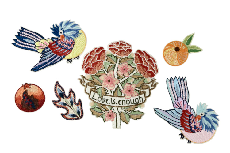 Set of colorful embroidered patches featuring birds and floral designs on a gray background.