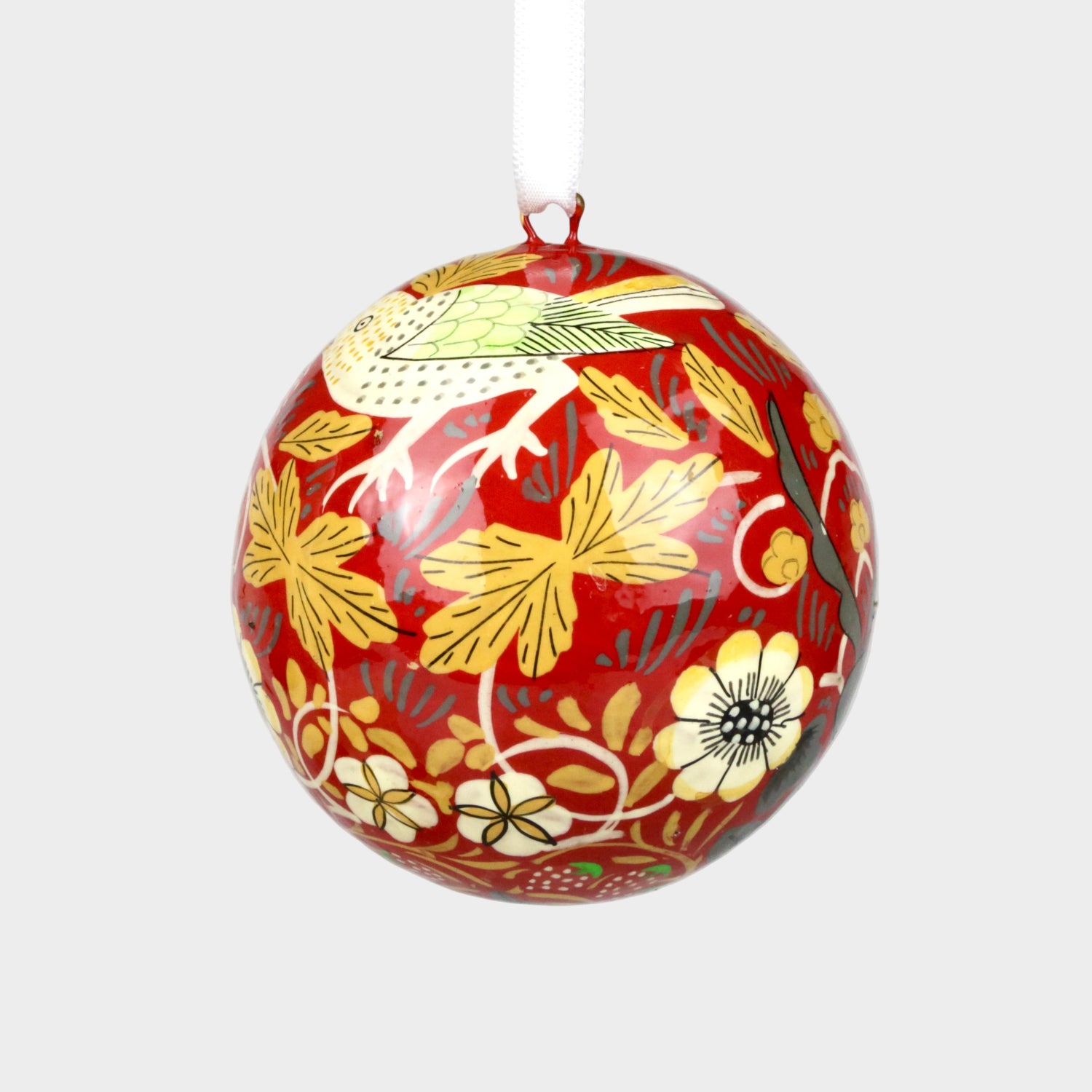 Decorative ball with floral and bird pattern on a plain background