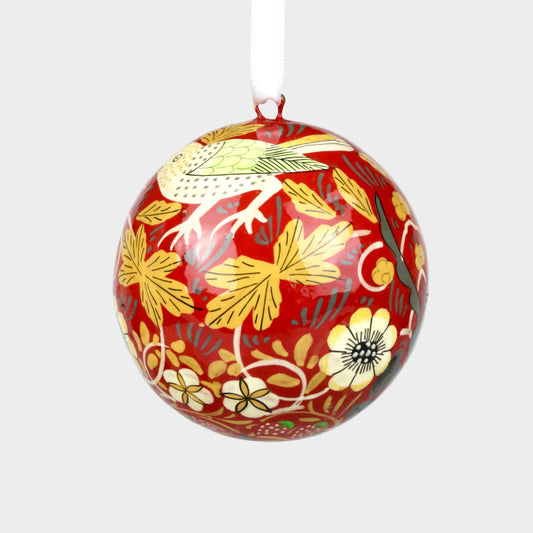 Decorative ball with floral and bird pattern on a plain background