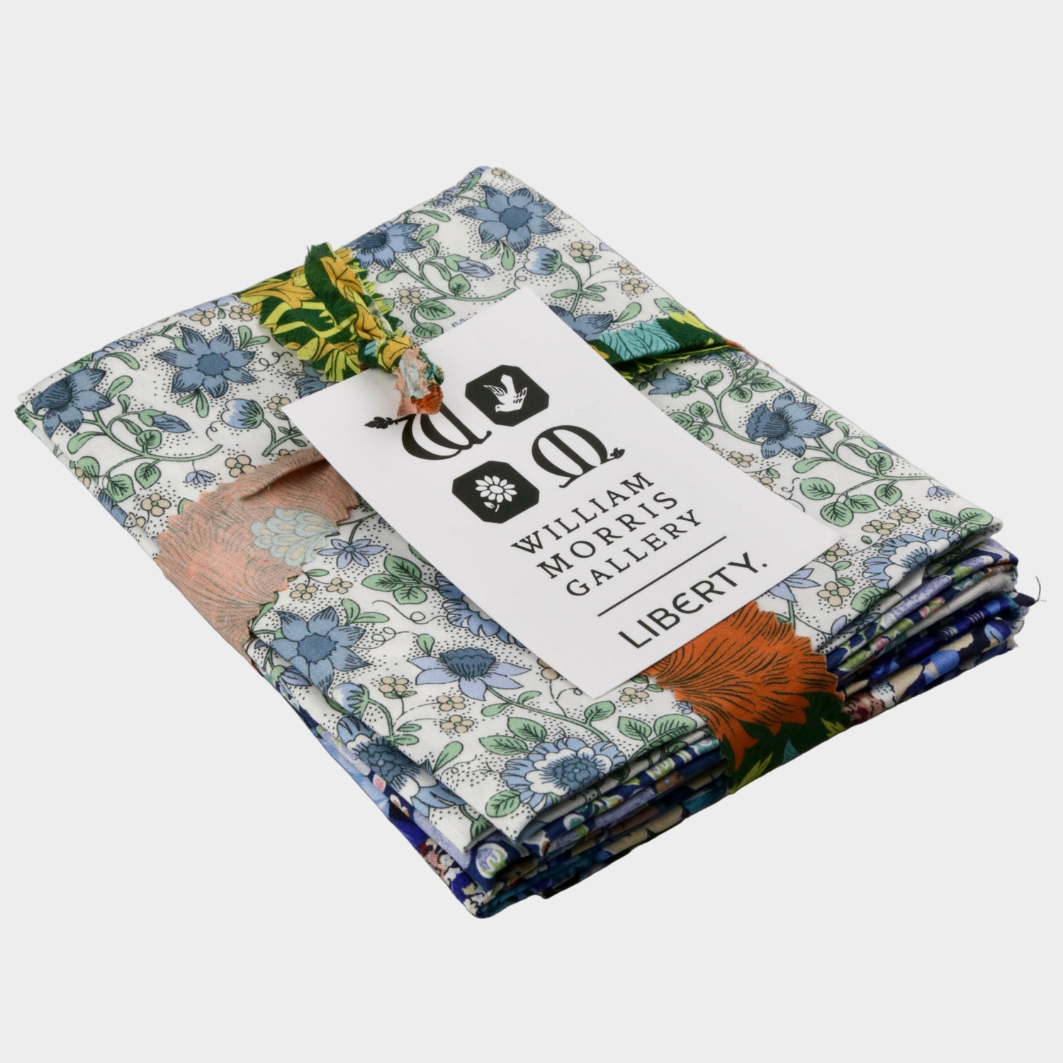 Stack of fabric swatches with a William Morris Gallery tag on a gray background