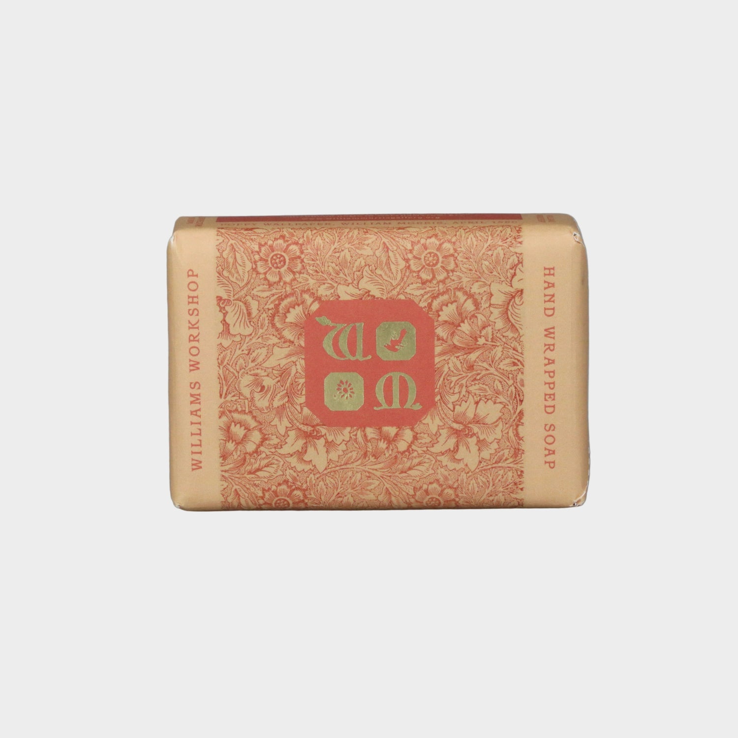 Bar of soap with decorative packaging featuring a logo on a gray background