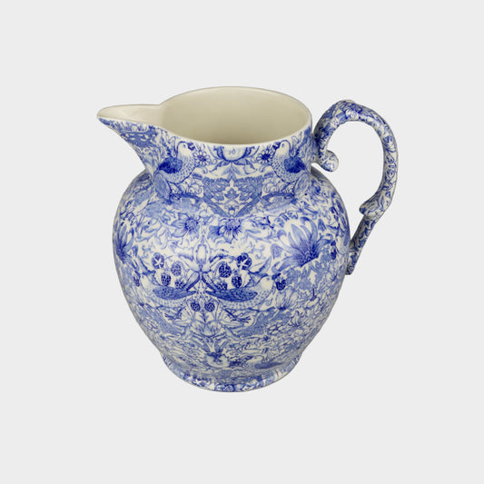 Blue and white ceramic pitcher on a gray background