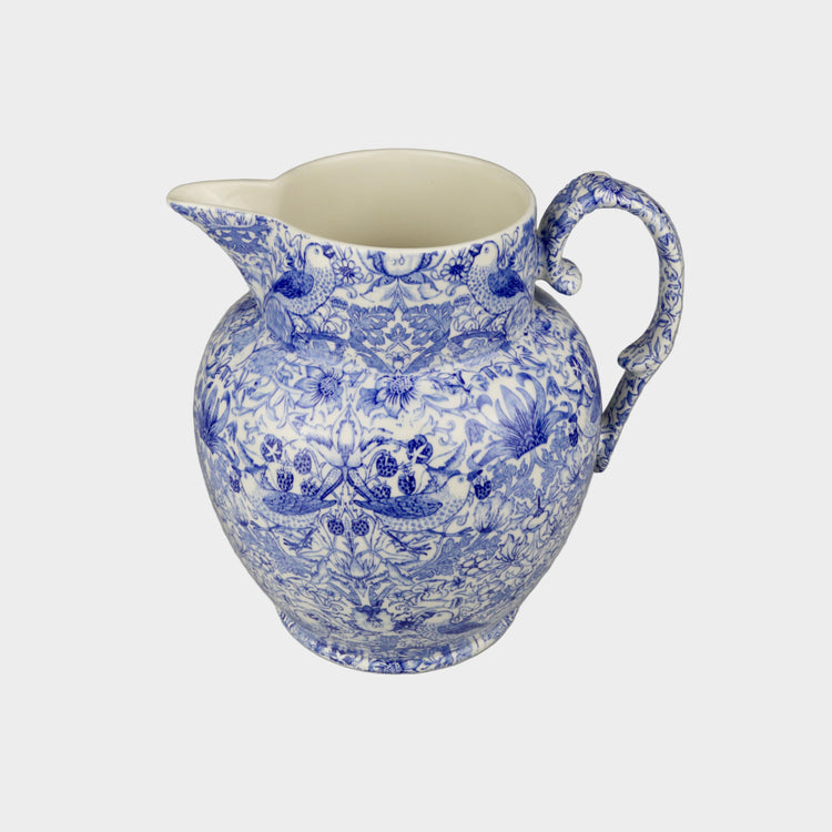 Blue and white ceramic pitcher on a gray background