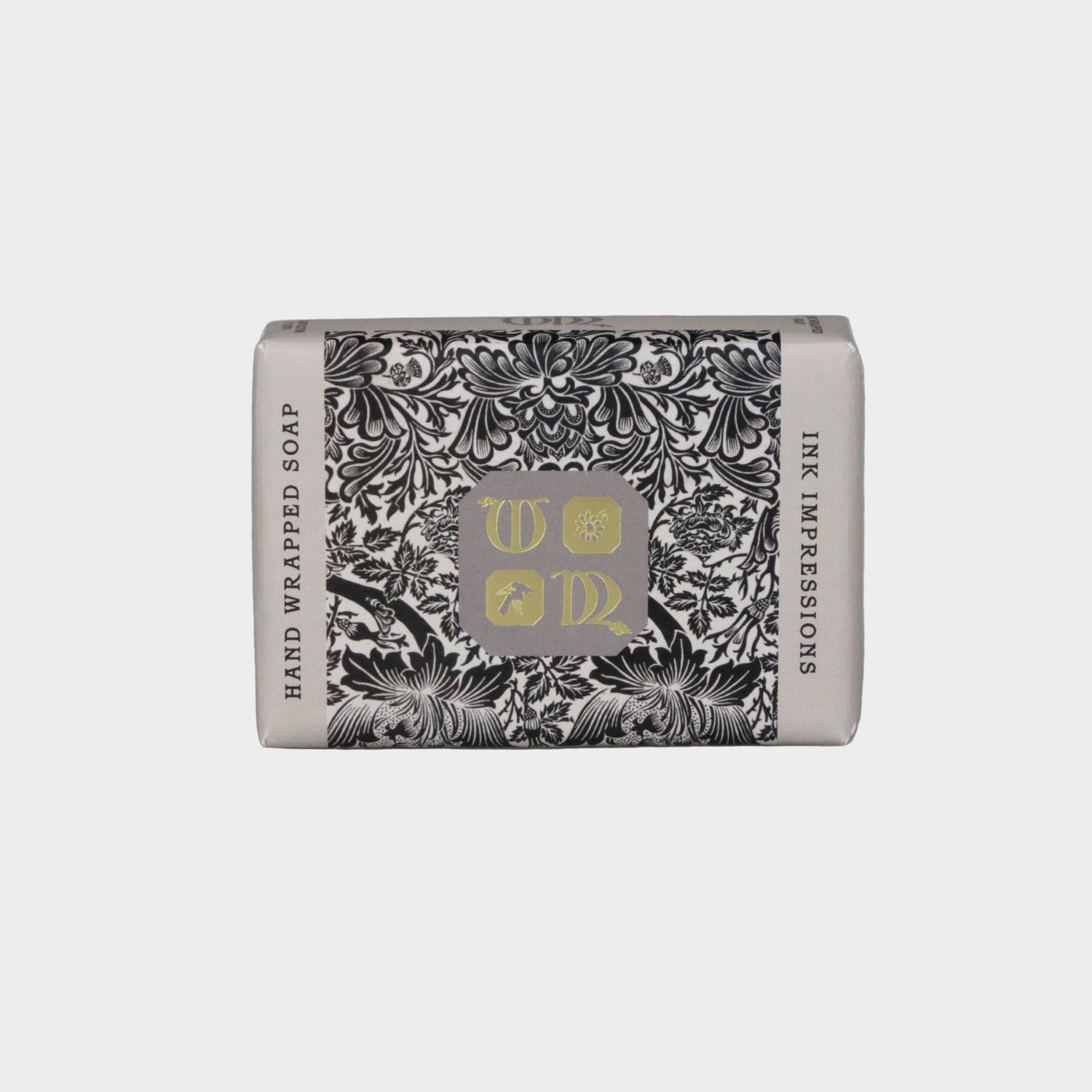 Hand-wrapped soap with decorative packaging on a gray background