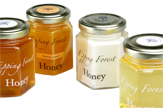 Four jars of Epping Forest Honey on a white background