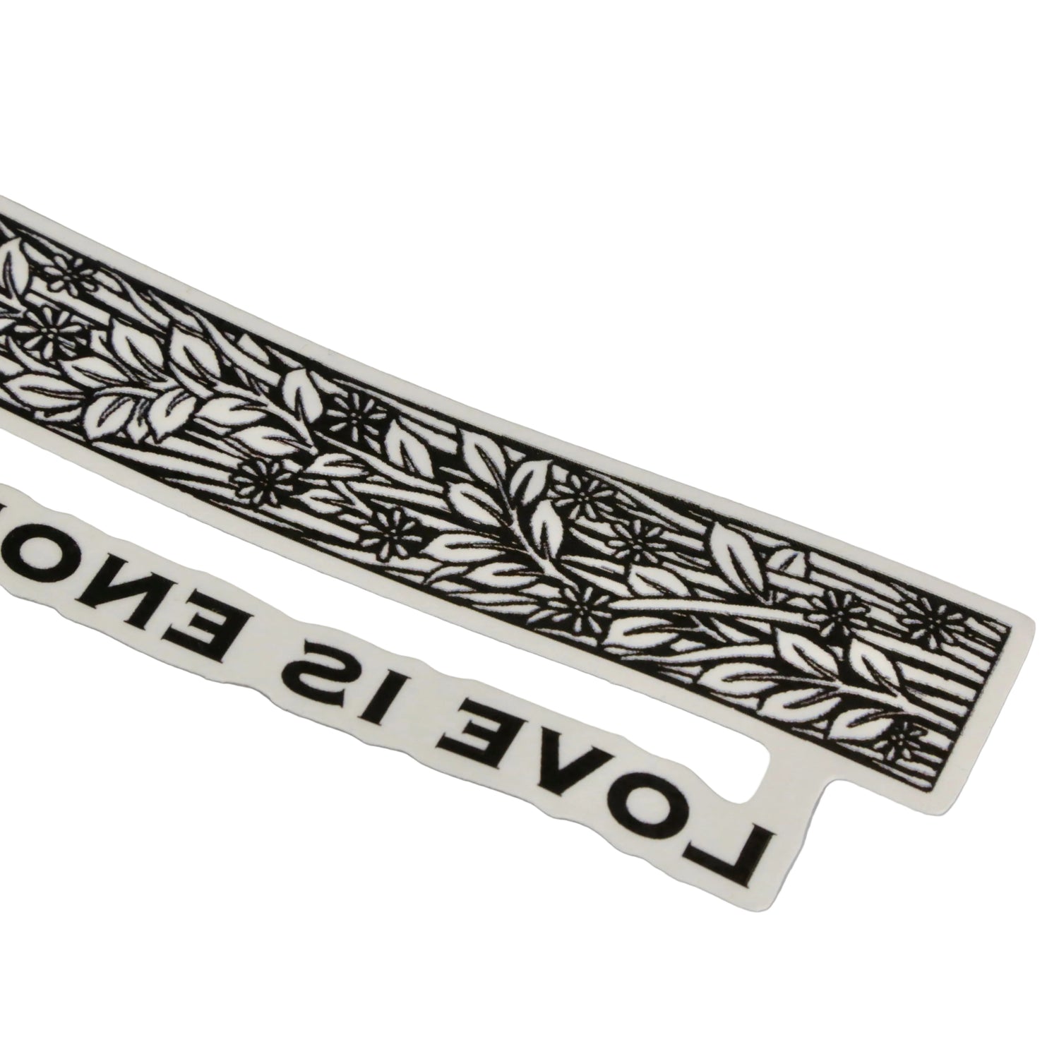 Decorative black and white strip with leaf pattern and text 'LOVE IS ENO' on a gray background