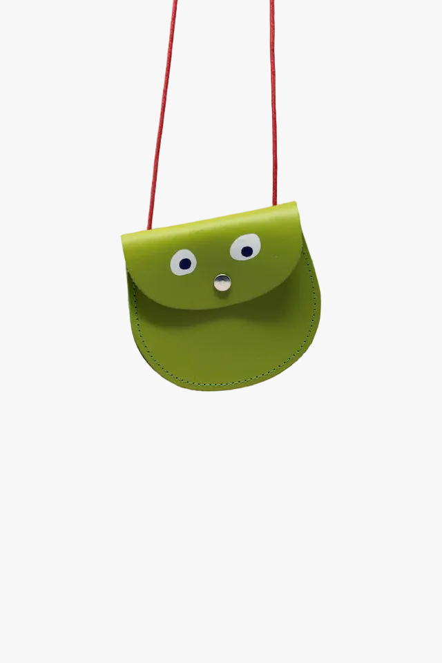 Green children's purse with face design on a white background