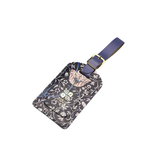 Floral patterned luggage tag with a purple strap on a light gray background