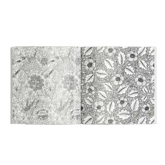 Open book displaying black and white floral patterns on a gray background